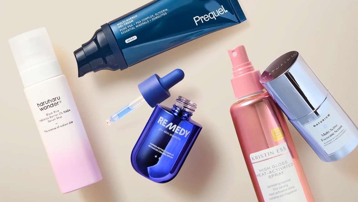 Fall skincare and haircare products arranged on a warm neutral background